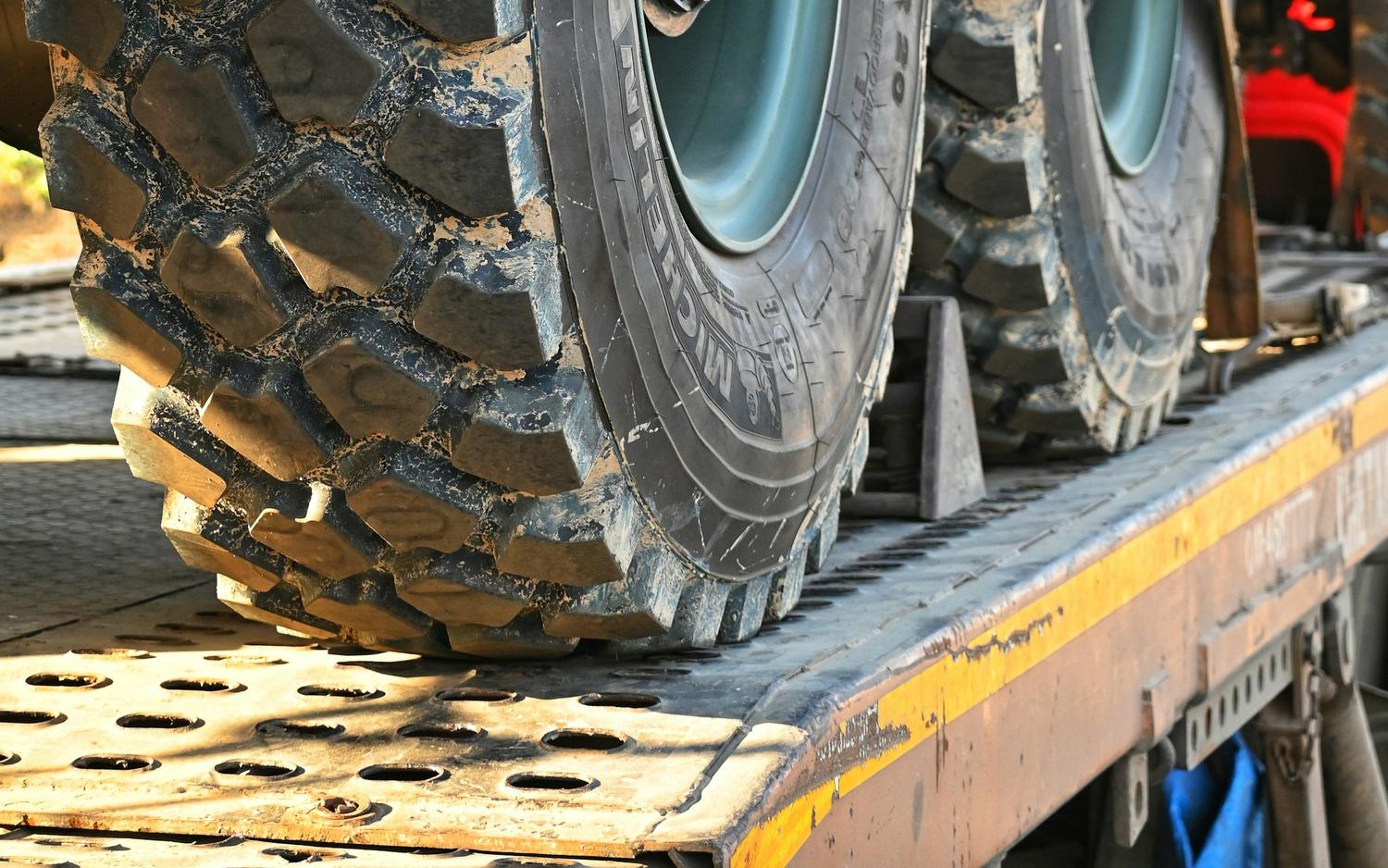 Flatbed trailer load secured for tiedown planning.