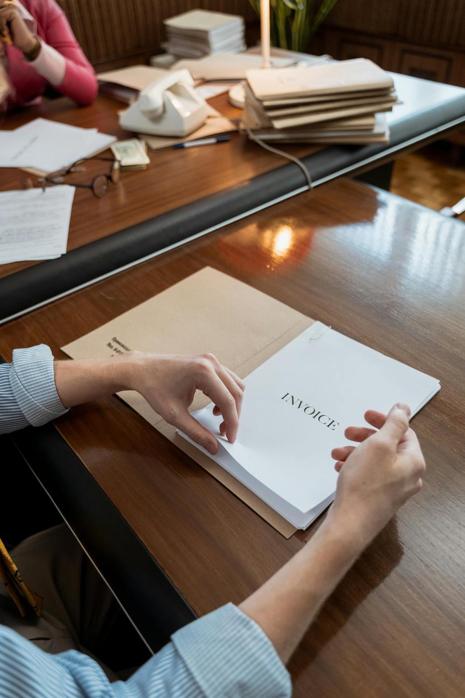 Invoice paperwork being reviewed for secure order-linked bank payment records.