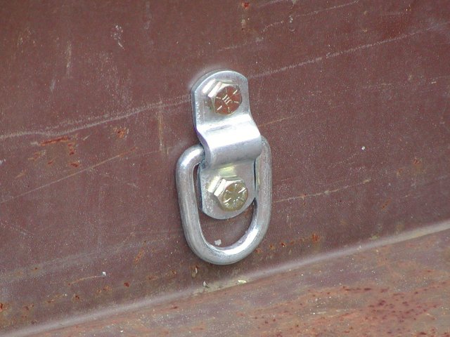 D-ring cargo tiedown mounted inside a utility trailer as public-domain application reference media