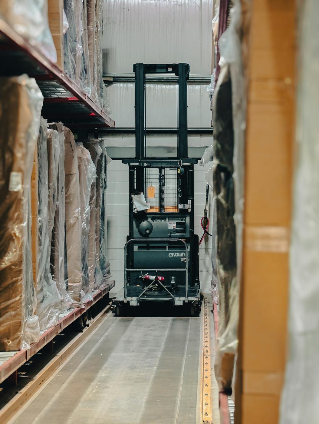 Forklift aisle staged for STZINC shipping, freight, and receiving review.